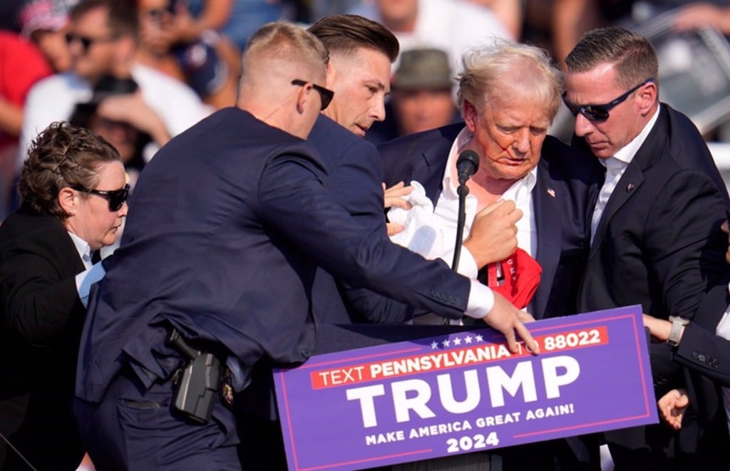 former President Trump is surrounded by U.S. Secret Service agents