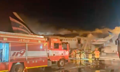 Firefighters extinguish flames from a fire that broke out in the tail section of an Air Busan Airbus A321 in South Korea