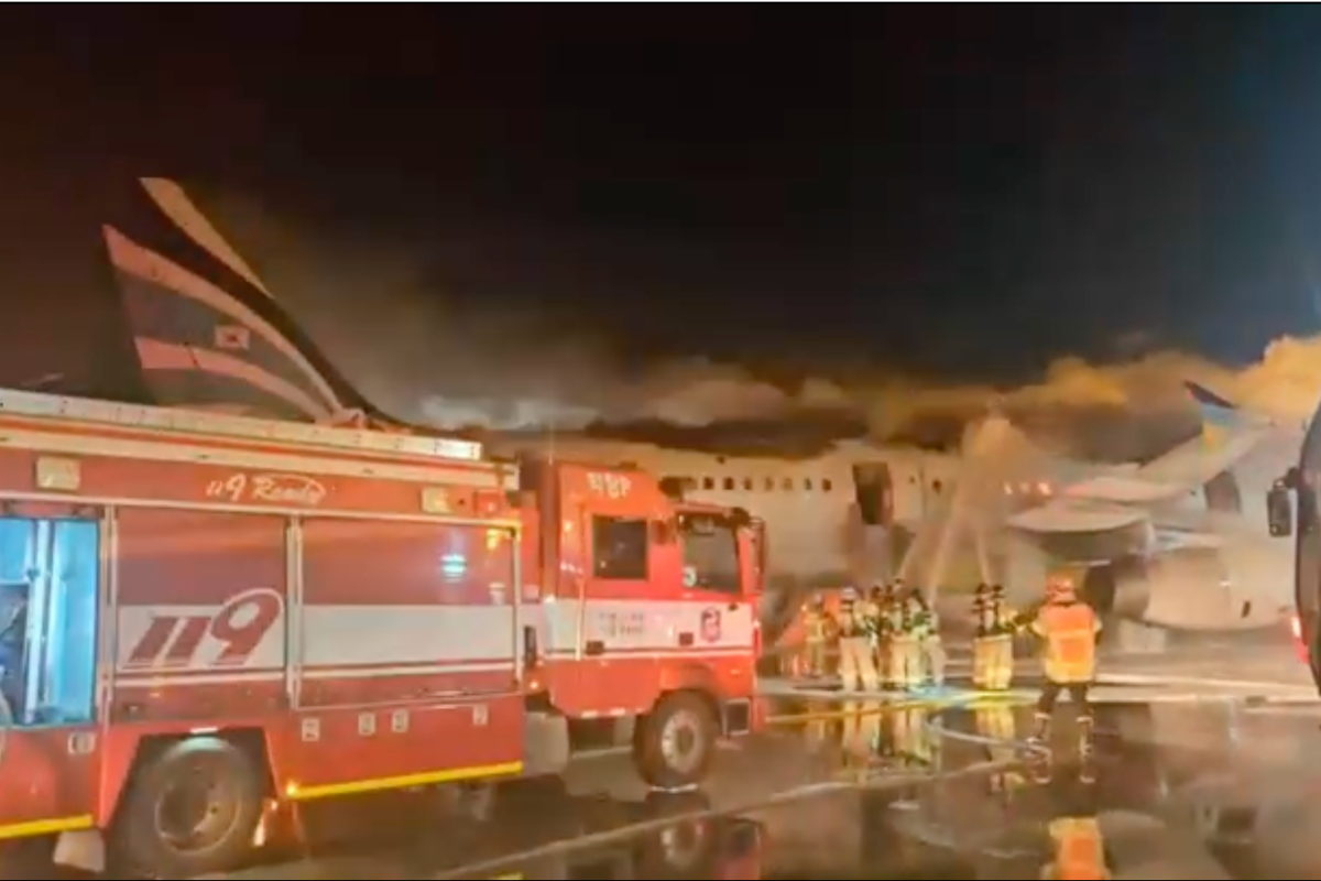 Firefighters extinguish flames from a fire that broke out in the tail section of an Air Busan Airbus A321 in South Korea