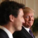 President Donald Trump smiles at Canadian Prime Minister Justin Trudeau